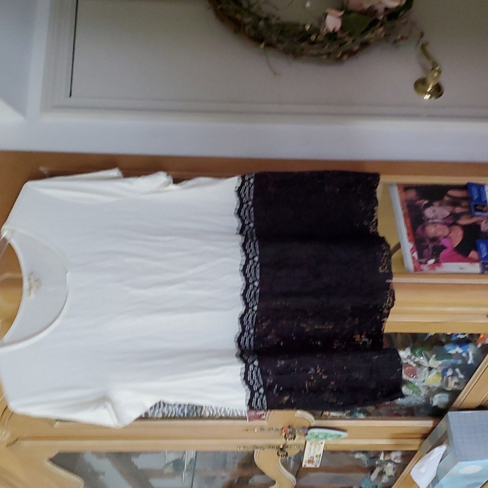 White shirt with black lace around bottom